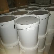 Several buckets of fresh honey in our storage room