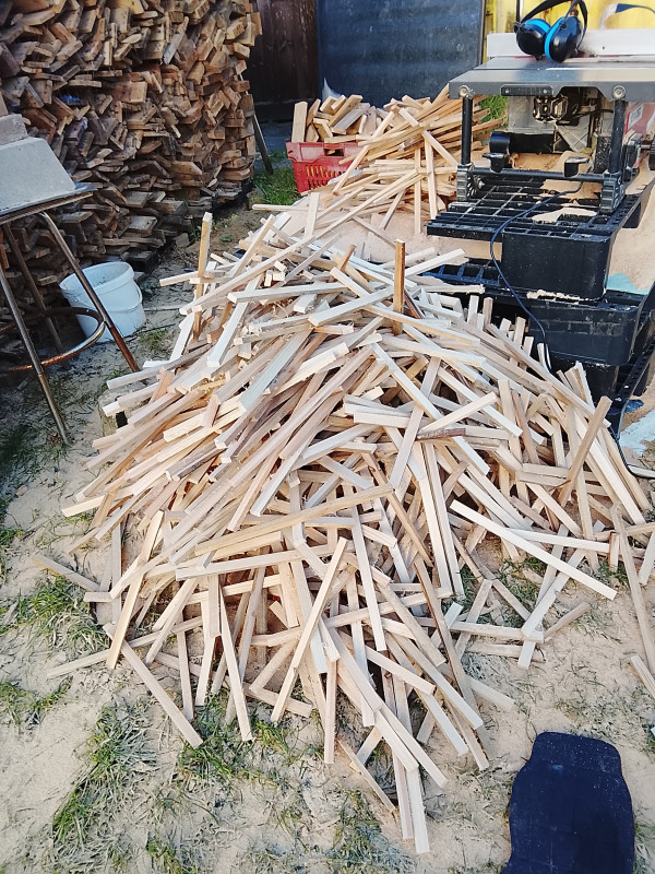 Boards cut into strips that will become new frame parts